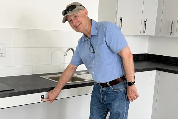 Councillor Chris Varley at the rise-and-fall worktop in one of the new kitchens at Ham Close