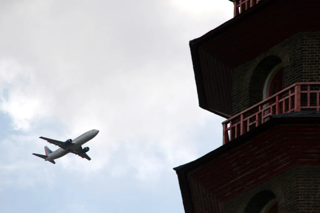 An airliner passes the Great Pagoda at Kew Gardens. A general view of the Heathrow approach over the borough, not a photograph of any flight described below