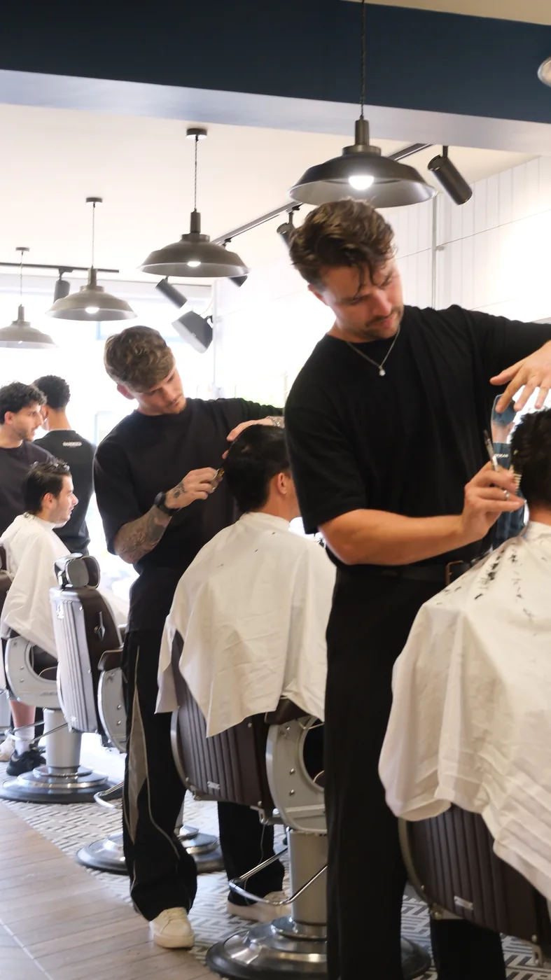 Barbers at work in Sammie's Studio shop